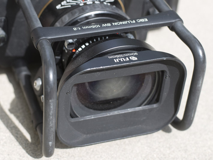 There is essentially a roll cage for added protection that's quite useful. The haze around the lens is the center filter that helps with vignette control, but reduces exposure by 2 stops. A shade should come with your lens.