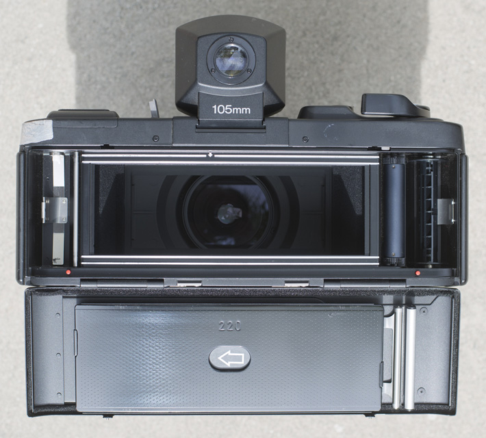 There's nothing between you and the inside of the lens. With this model, the back stays attached to the body.