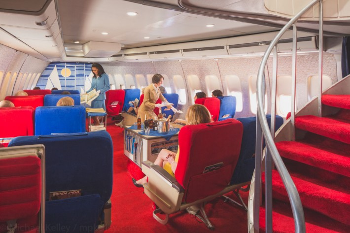 After boarding, champagne and snacks are given to passengers eagerly awaiting their trips, and elegant gold-stamped menus featuring cuisine from around the world are distributed. Passengers begin to settle in with magazines, and luckier ones are, unbeknownst to them, given pieces of Pan Am history.