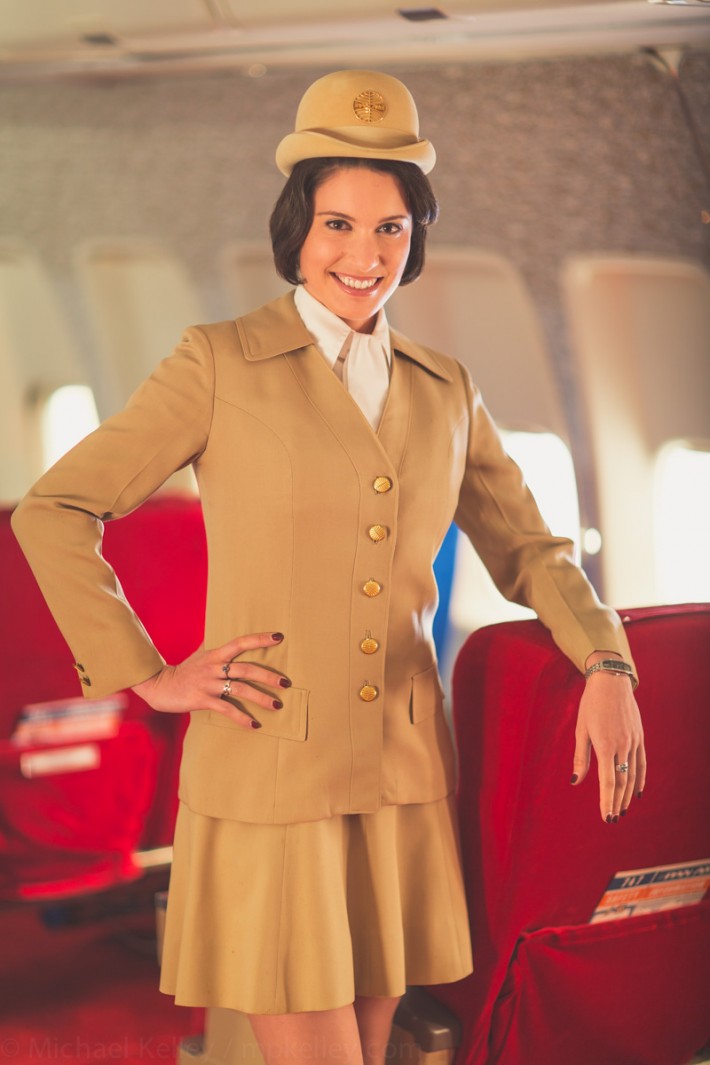 Before boarding, stewardesses prepare the forward cabin for arriving passengers. Magazines, headsets, blankets and pillows. There would typically be at least four flight attendants servicing the forward first class cabin.